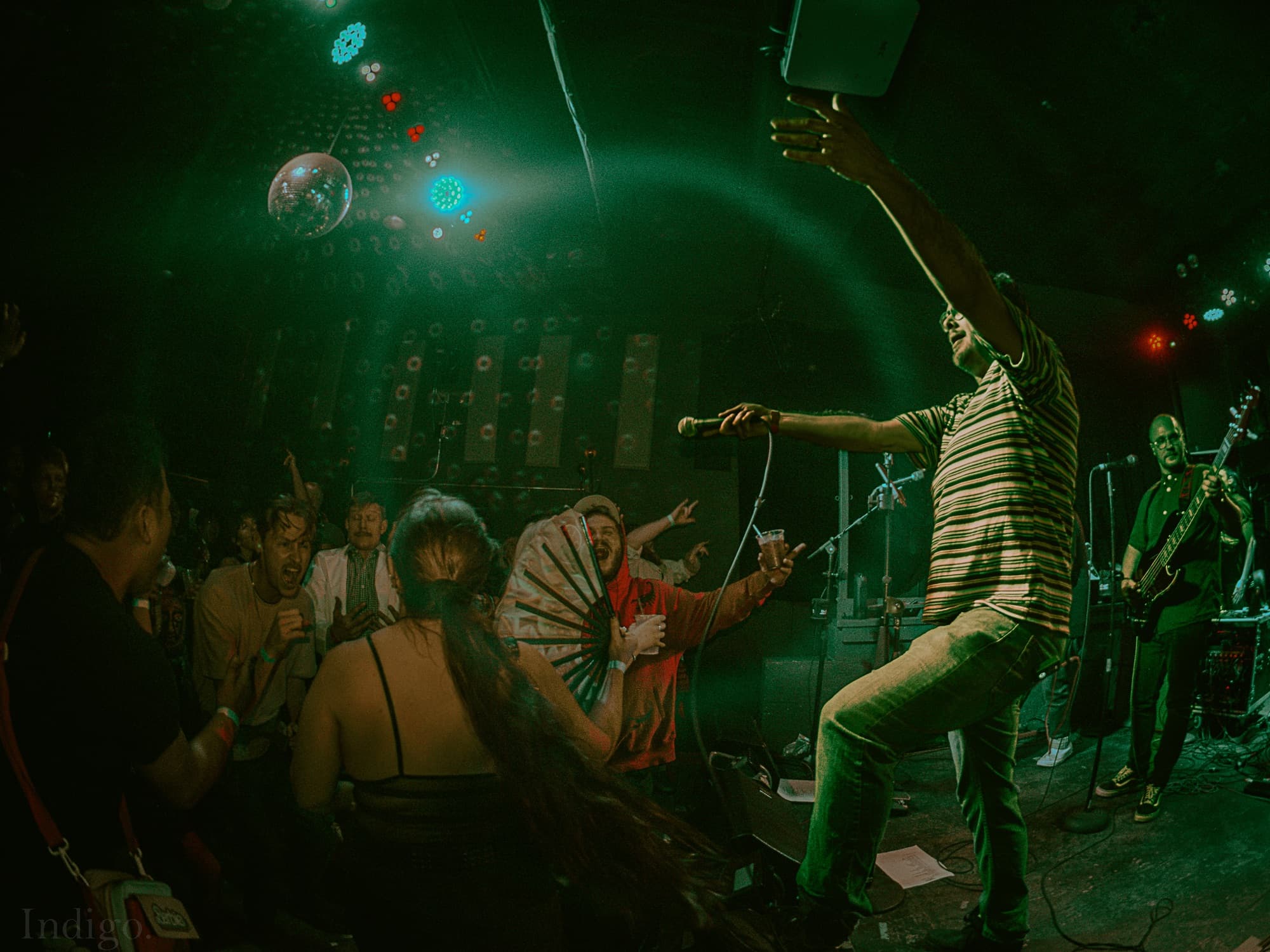 Vocalist performing with green spotlight halo