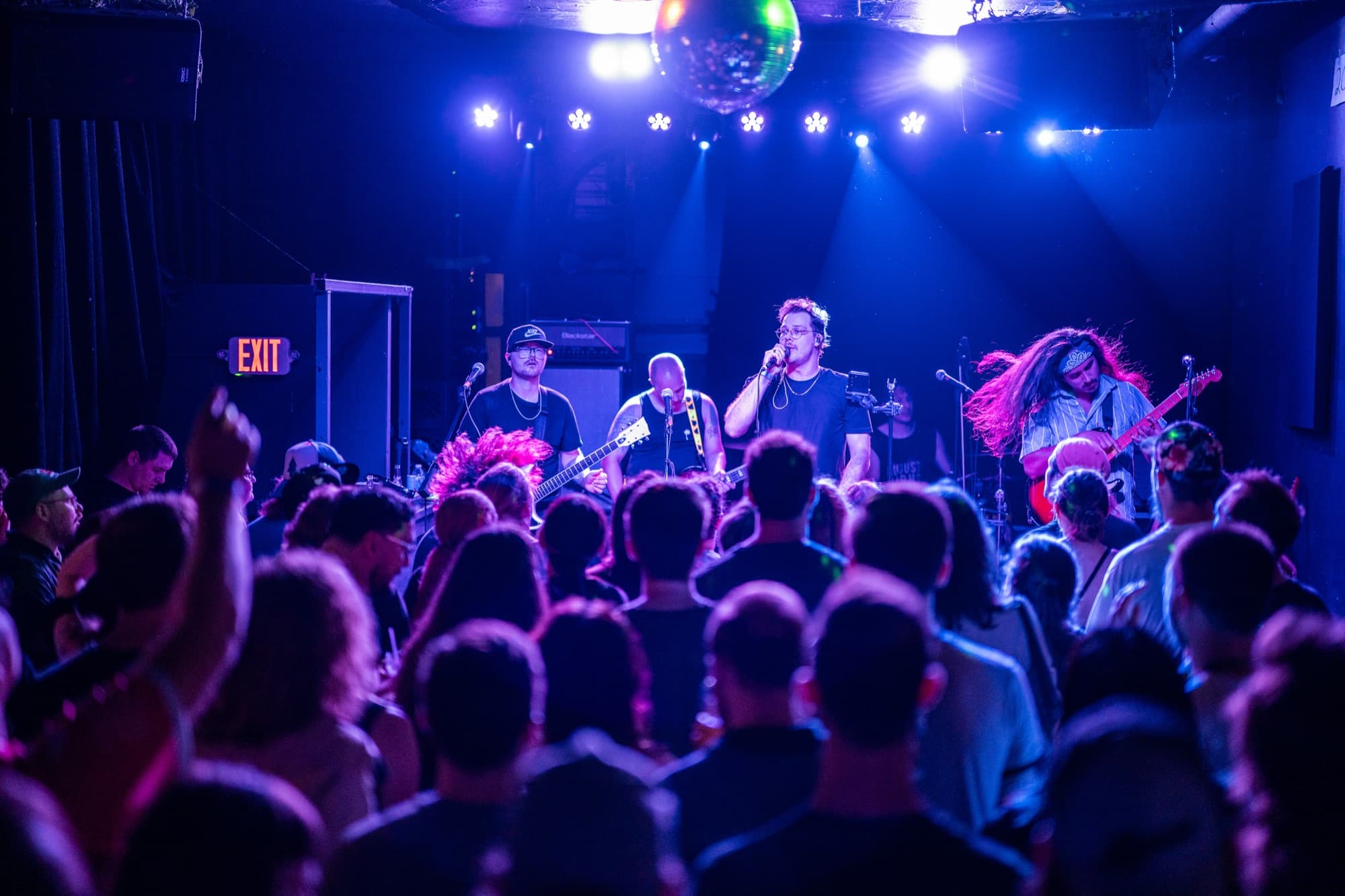 Full band on stage with crowd