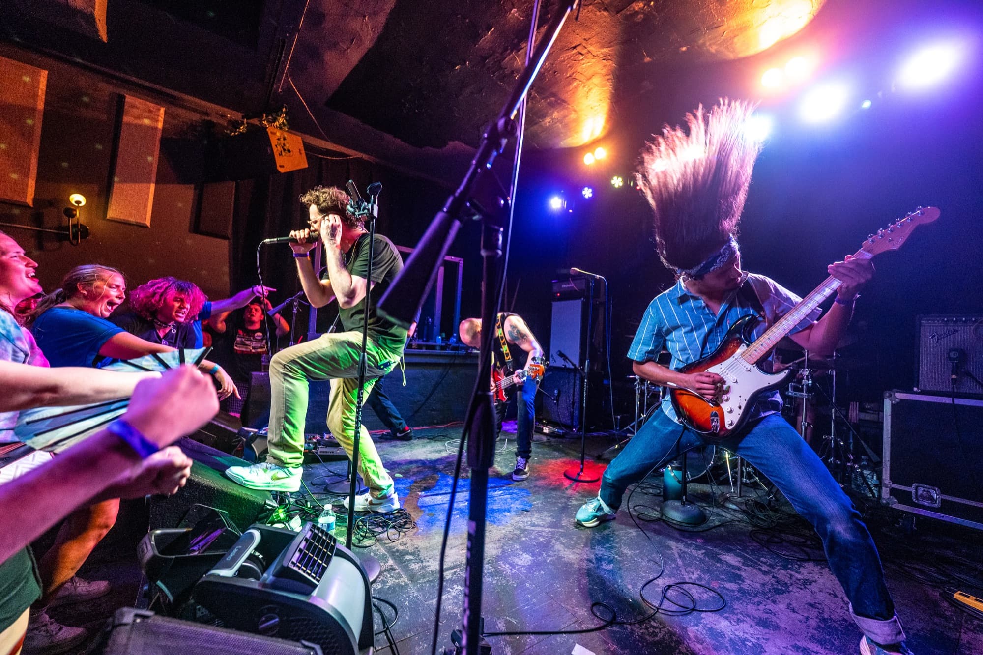 Vocalist and guitarist headbanging on stage
